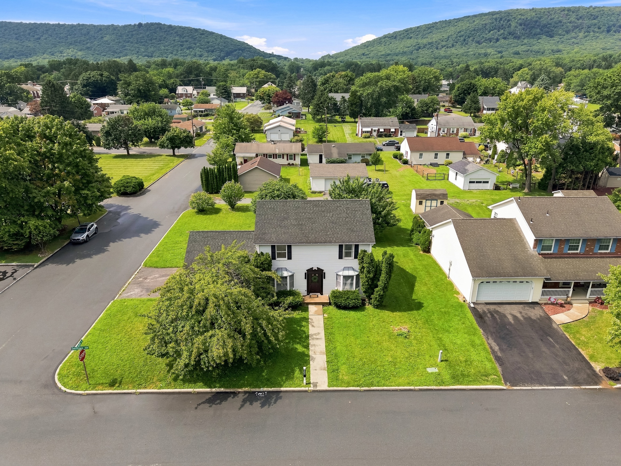 Aerial view of a home and its mountain surroundings