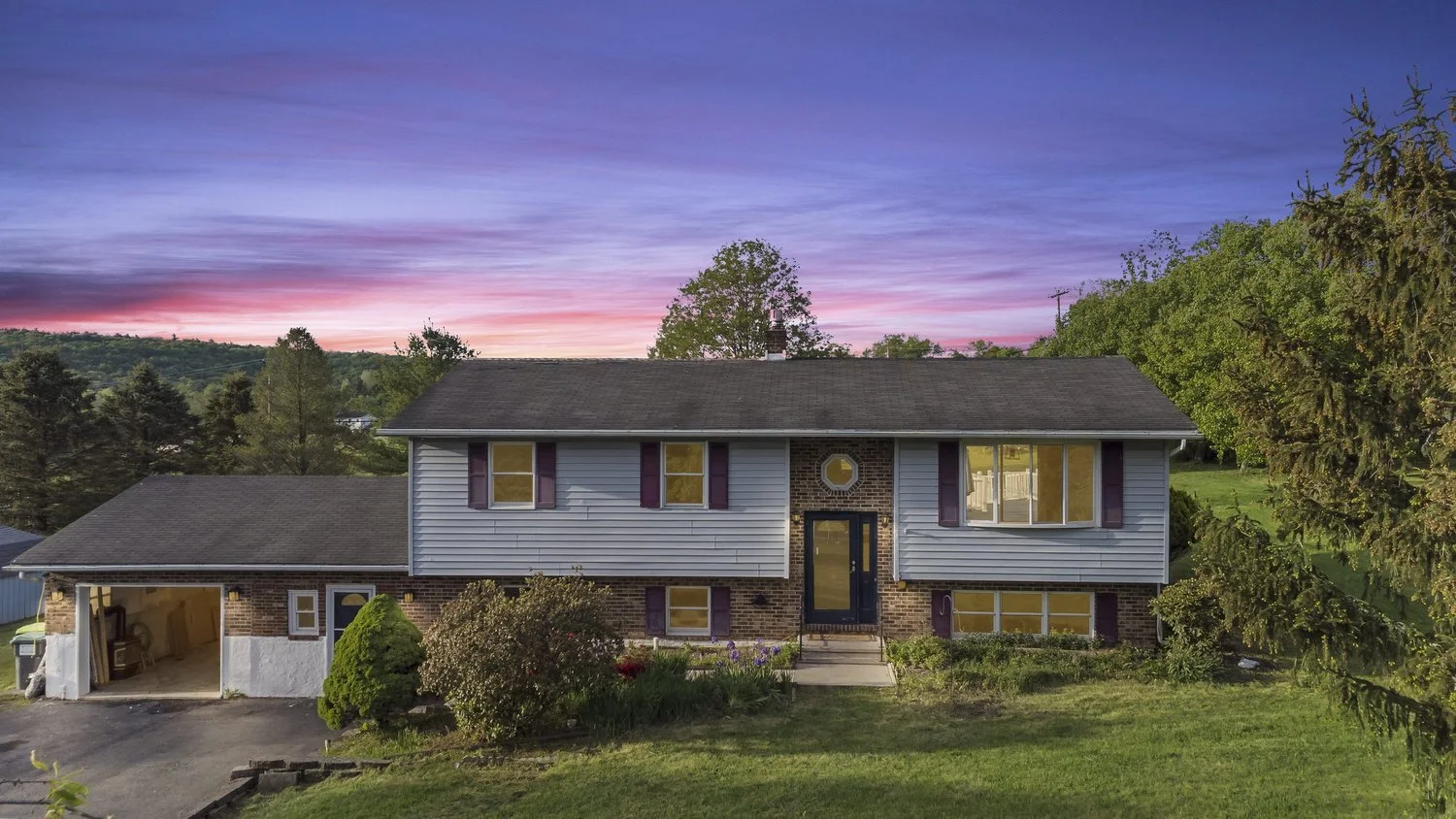 Split-level home under a colorful twilight sky